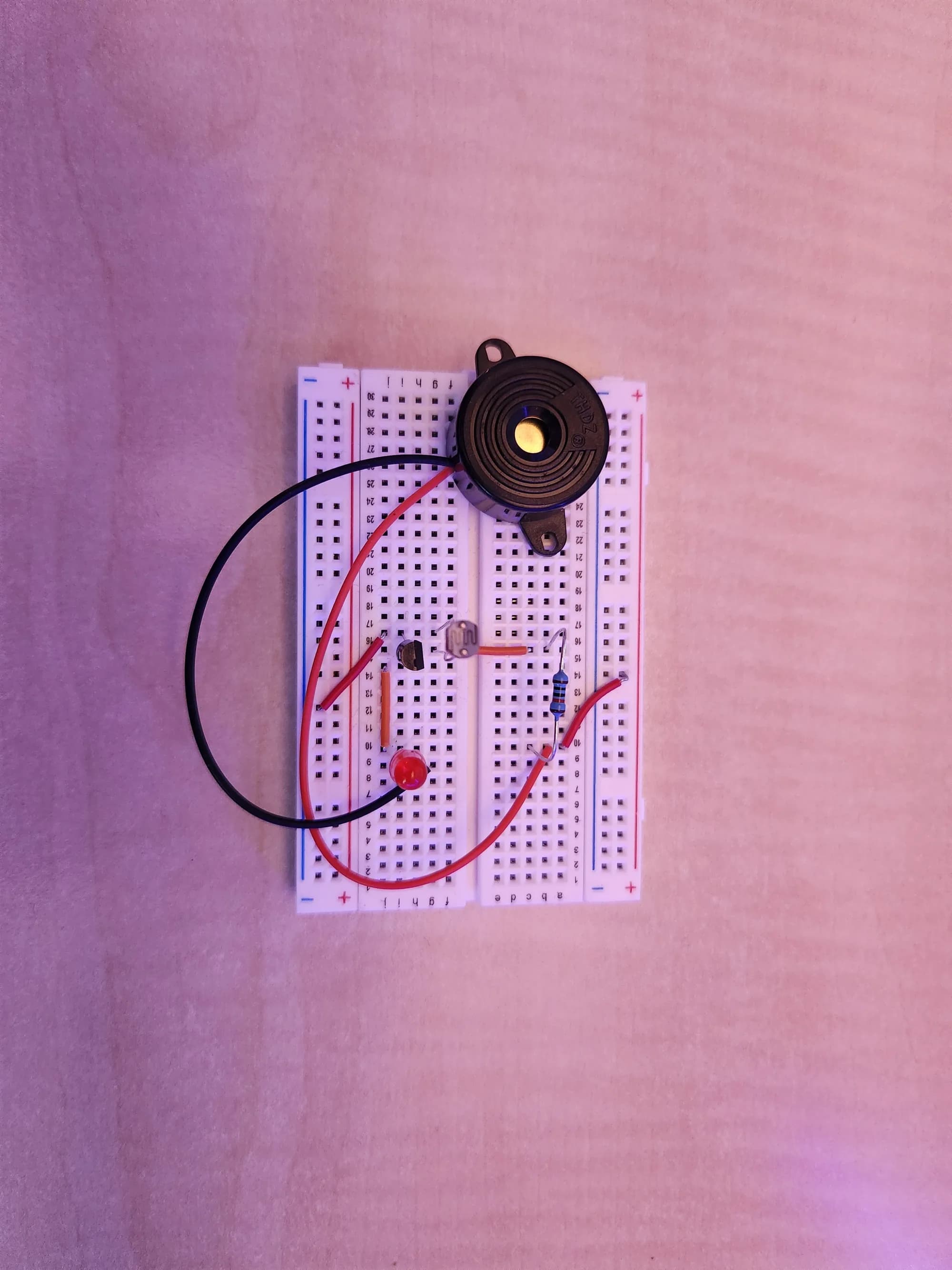 Close-up photograph of the buzzer and LDR wiring on the breadboard
